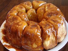 a bundt cake covered in caramel sauce on a white plate