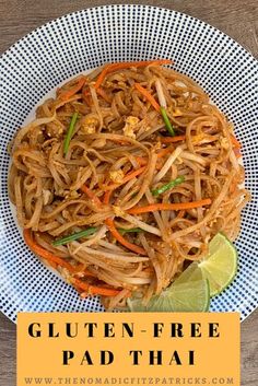 a plate full of pad thai noodles with carrots, onions and green peppers on top