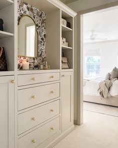 a white dresser with drawers and a mirror