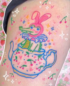 a woman's thigh with an image of a rabbit in a teapot on it