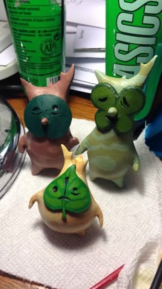 three small figurines sitting on top of a paper towel