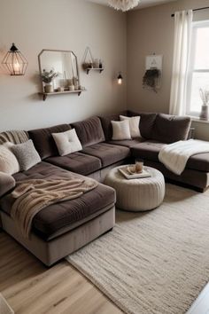 a living room with a large sectional couch and ottoman in the corner, along with a rug on the floor