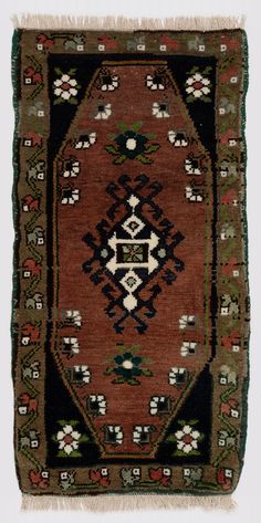 an old rug with many different colors and designs on it's sides, including the center