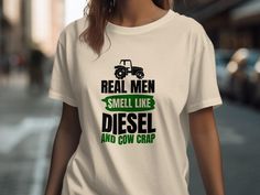 This funny tractor farmer T-shirt is perfect for anyone who loves farming. Featuring the humorous statement "Real Men Smell Like Diesel and Cow Crap," this unique farm shirt is an ideal gift for farmers. It's a fun way to show off your passion for agriculture and make everyone laugh. Perfect for casual wear or working on the farm. **Shipping Our standard shipping time is 2-5 business days once your order is processed. We do our best to ship items quickly, and you'll receive a tracking number as soon as it's on its way.  **Refunds/Exchanges All of our shirts are custom printed just for you, so we do not accept returns or exchanges due to size unless there are printing issues or damage. If there are any issues with your item, please message us. **Care Instructions Machine wash cold, inside-o John Deere Cute Shirts, Agriculture Shirt, Farm Tees, Gifts For Farmers, Real Men, On The Farm, Real Man, The Farm, Agriculture