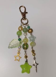 a close up of a key chain with beads and charms hanging from it's side