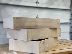 two wooden boxes stacked on top of each other