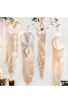 three wall hangings decorated with lights and decorations