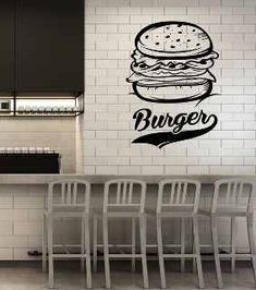 a wall decal that says burger on it next to some bar stools in a kitchen