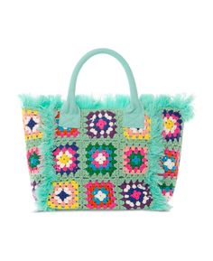 a green handbag with multicolored flowers and fringes