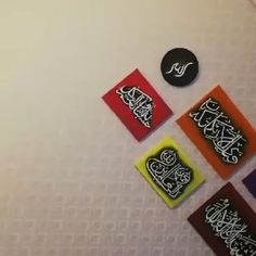 four different types of stickers on a white surface with black and red squares in the middle