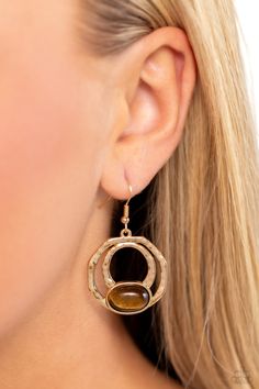 An oval tiger's eye stone is pressed into the bottom of a layered geometric gold frame radiating with hammered texture, resulting in an earthy and edgy trinket. Earring attaches to a standard fishhook fitting. Featured inside The Preview at Made for More! Sold as one pair of earrings. Bedazzled Jewelry, Tigers Eye Gem, Ear Cuff Jewelry, Tiger Eye Earrings, Brown Earrings, Refined Aesthetic, Jewelry Catalog, Costume Earrings, Fish Hook Earrings