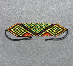 This beautiful beaded bracelet is hand-woven by the women of the Embera Chami Indigenous Tribe of Colombia Artisan Woven Beaded Bracelets For Beach, Traditional Adjustable Fair Trade Beads, Traditional Handwoven Jewelry, Traditional Handwoven Rectangular Jewelry, Traditional Multicolor Beaded Bracelets Fair Trade, Traditional Fair Trade Beaded Bracelets For Gifts, Traditional Woven Braided Bracelets For Festivals, Multicolor Woven Braided Bracelets With Round Beads, Traditional Adjustable Fair Trade Beaded Bracelets