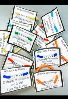 some cards that are made to look like children's handmade bracelets with writing on them