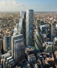 an aerial view of the city with skyscrapers and other buildings in the foreground