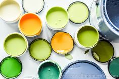 many different colors of paint are in buckets