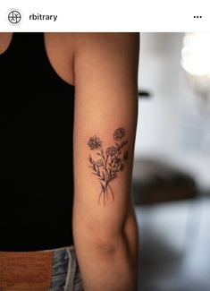 a woman's arm with flowers on it and the words tattoo written in black ink