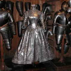 a metal dress and armor on display in a room