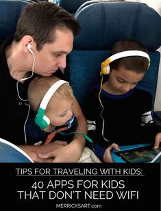 a man and two children sitting on an airplane with headphones in their ears while looking at a tablet