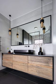 a bathroom with a large mirror and two sinks