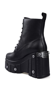 Bring bold biker edginess to your footwear collection with this heavy-duty combat boot set upon a lugged platform wedge studded with rivet-style screws and bolts. 4" heel; 3" platform 6" shaft Lace-up style Water resistant Leather upper and lining/rubber sole Imported Gothic Leather Combat Boots With Platform, Leather Platform Combat Boots For Alternative Fashion, Alternative Style Platform Boots With Studded Outsoles, Edgy Combat Boots With Chunky Platform, Edgy Leather Wedge Boots For Alternative Fashion, Alternative Leather Platform Wedge Boots, Edgy Leather Wedge Boots With Chunky Platform, Alternative Leather Moto Boots With Chunky Platform, Edgy Leather Wedge Boots With Platform