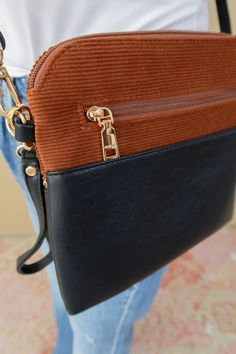 Elevate your style with our Brown/Black Tara Crossbody Bag! Crafted from chic corded fabric and contrasting faux leather, this bag features gold metal accents and an adjustable strap for the perfect fit. Plus, keep your belongings safe with the convenient zip closure. -Height: 8.5" -Width: 9" Trendy Crossbody Bag With Leather Trim, Chic Pouch Shoulder Bag With Leather Trim, Trendy Brown Bag With Leather Trim, Versatile Brown Bags With Leather Trim, Versatile Brown Bag With Leather Trim, Trendy Black Shoulder Bag With Leather Trim, Athletic Dresses, Denim Gift, Metal Accents