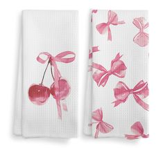 two towels with pink bows and cherries on them