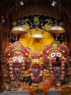 an elaborately decorated shrine with masks and lights in the center, surrounded by other decorations