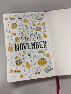 an open notebook with the words hello november written in black and yellow doodles on it