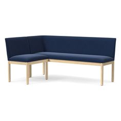 the corner bench is made from wood and blue fabric