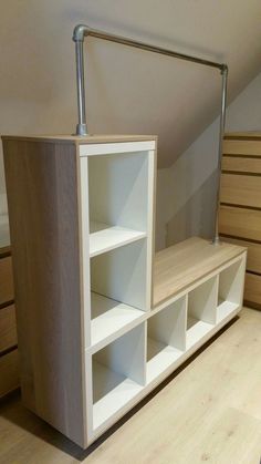 a white shelf with shelves underneath it on top of a hard wood flooring area