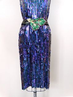 "This is a dazzling vintage dress. It's fully embellished with glass beading and sequins and in perfect condition! Measurements: Bust - 36\" Waist - 36\" Hips - 36\" Length - 41\" This dress comes from a pet-free and smoke-free home. If you would like more info or have any questions, please don't hesitate to ask!" Iridescent Sequin Dresses For Party Season, Elegant Iridescent Dress For Evening, Purple Sequined Evening Dress For Cocktail, Vintage Style Embellished Evening Dress For Party, Vintage Evening Sequin Dress, Fitted Iridescent Dress For Evening, Purple Sequin Cocktail Dress, Purple Sequined Cocktail Evening Dress, Purple Embellished Sequin Dress For Cocktail