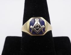 Add a touch of timeless elegance to your style with this exquisite Masonic 14K solid gold men's vintage ring. Featuring the iconic G compass and square emblem delicately engraved on a stunning blue stone, this ring is a symbol of brotherhood and tradition. Wear this unique piece with pride and showcase your Masonic heritage in a sophisticated and refined way.  Details: Metal: Solid Yellow Gold marked 14 K Size: 10-1/2 Condition:  Very good A perfect accessory for any occasion, this ring is sure Formal Engraved Ring With Maker's Mark, Classic Rectangular Signet Ring Collectible, Classic Adjustable Engraved Ring Stamped 14k, Classic Formal Jewelry With Compass Design, Classic Rectangular Collectible Signet Ring, Classic Compass Design Jewelry For Anniversary, Classic Yellow Gold Jewelry With Maker's Mark, Classic Jewelry With Compass Design For Anniversary, Symbolic Formal Signet Ring With Polished Finish