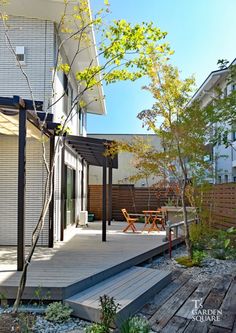 an outdoor deck and patio area with wooden steps