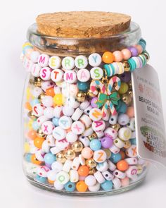 a jar filled with lots of colorful beads