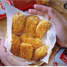 someone is holding some fried food in their hand and it looks like they are ready to eat