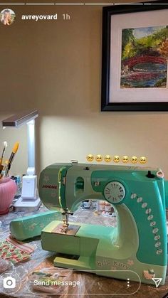 a green sewing machine sitting on top of a table