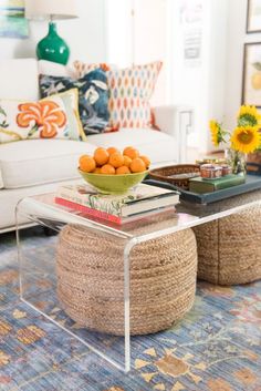 a living room filled with lots of furniture and flowers on top of a table in front of a white couch