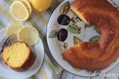 a lemon bunt cake on a plate next to sliced lemons