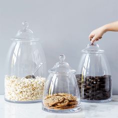 three clear glass containers with cookies in them