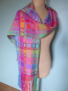 This eyecatching scarf is woven using many different coloured hand dyed silks in a double weave which means that the shawl is double sided - with a different effect on each side. I used quite fine silks, woven in two layers which interchange at irregular intervals to give further colours and patterning. It took me many hours to create this scarf as I was, in effect, weaving two scarves at once - one on top of the other, alternating two shuttles throughout the piece. There are too many colours to Multicolor Handloom Silk Scarf, Multicolor Hand Dyed Silk Scarves, Multicolor Woven Scarves One Size, Traditional Handwoven Multicolor Scarves, Multicolor Woven Shawl Scarves, Multicolor Handwoven One-size Shawl, Double Weave, Hot Iron, Lightweight Scarf