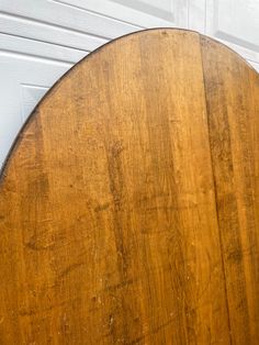 an old wooden table sitting in front of a garage door