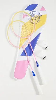 three badminton rackets and two shuttles laying on top of each other with the same design