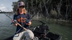 a man on a boat holding two fishing rods