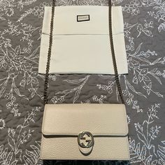 Gucci Limited Edition Embossed Ivory Leather With Light Fine Gold Chain And Leather Strap. ***Includes Box And Dust Bag Interior Has 18 Card Slots And One Zip Pocket With Open Space Compartment Exterior Has Light Gold Gg Snap Closure Measures 7.5”X4.5”X1.5” With A 22” Chain Drop White Gucci Shoulder Bag With Chain Strap, Gucci Rectangular Wallet On Chain With Chain Strap, Gucci Wallet On Chain With Rectangular Shape, Luxury Beige Wallet On Chain For Evening, Classic Gucci Wallet On Chain In Rectangular Shape, Classic Rectangular Gucci Wallet On Chain, Gucci Classic Rectangular Wallet On Chain, Beige Evening Wallet On Chain With Chain Strap, Beige Wallet On Chain With Chain Strap For Evening