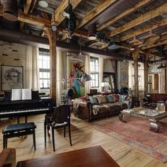 a living room filled with furniture and lots of windows