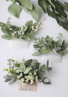 three hair combs with flowers and greenery on them