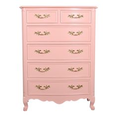 a pink chest of drawers with gold trimmings on the top and bottom drawer