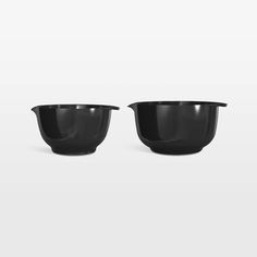 two black bowls sitting next to each other