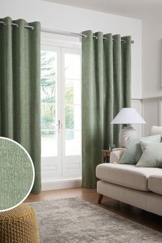 a living room with green curtains and a white couch in front of a sliding glass door