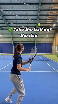 a woman holding a tennis racquet on top of a tennis court with the words take the ball on the rise above her head